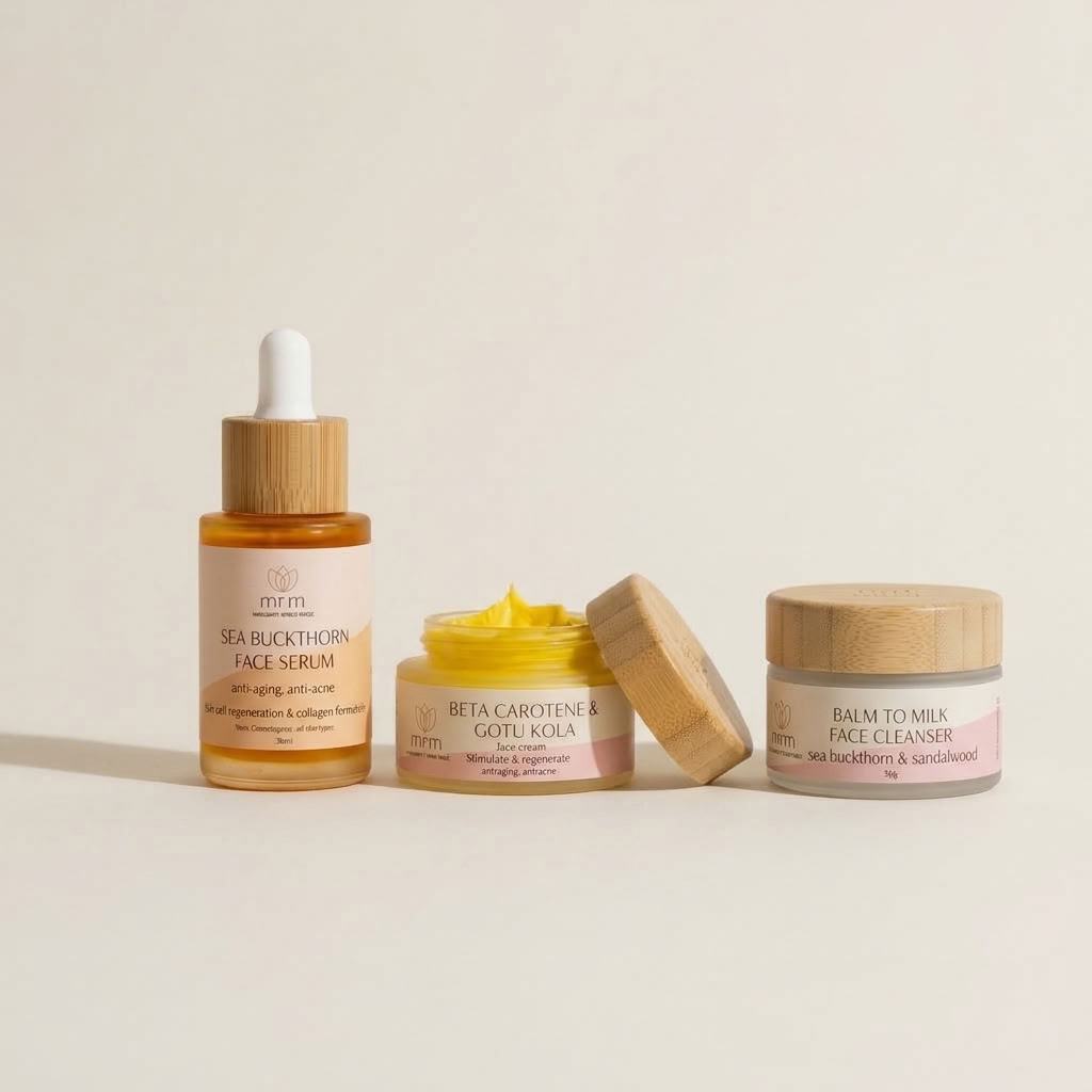 Three skincare products from the brand mrm on a warm off-white background: a sea buckthorn face serum in an amber dropper bottle, a beta carotene & gotu kola cream jar with its wooden lid leaning beside it, and a bath to milk face cleanser jar with a wooden lid.