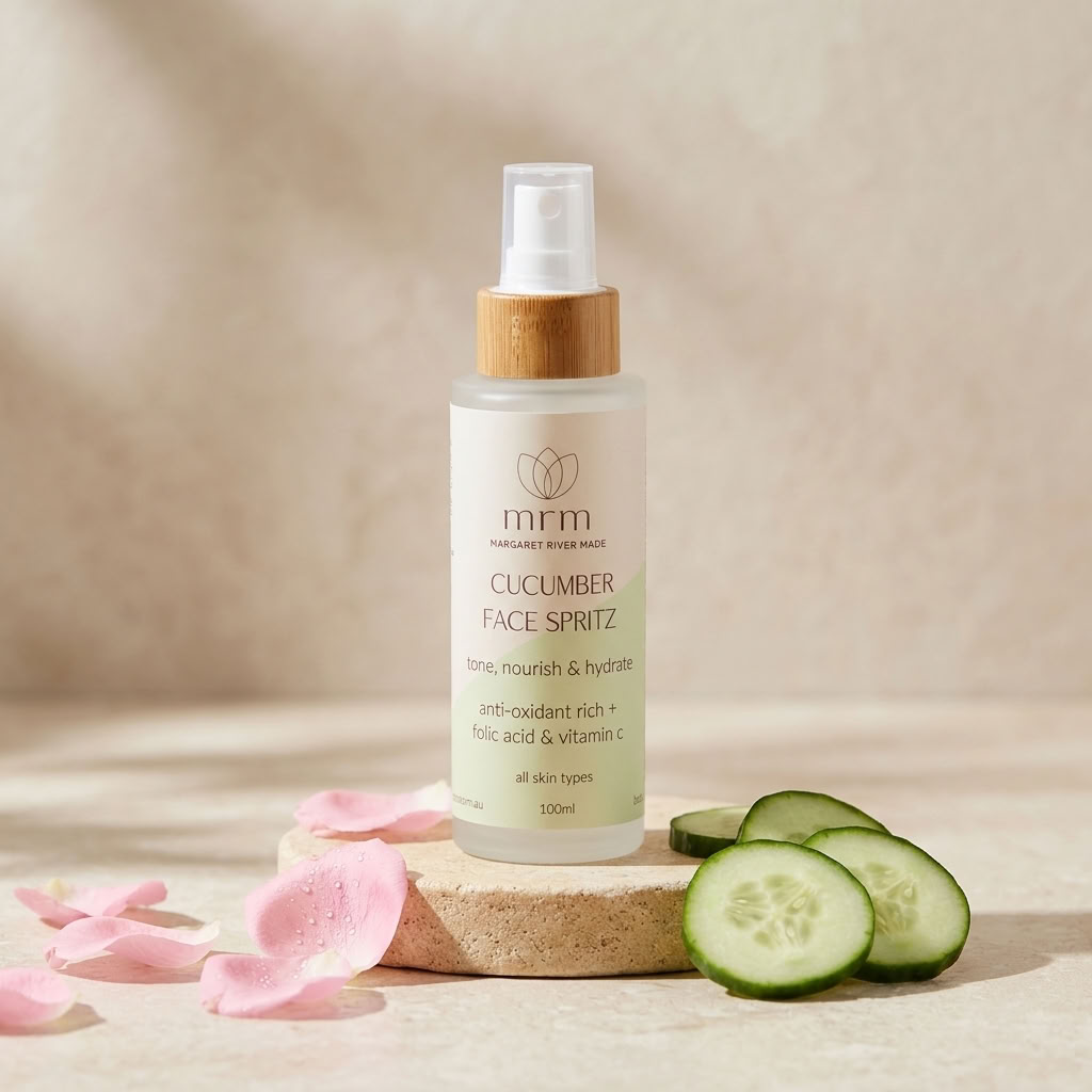 A 100ml bottle of MRM Natural Beauty Face Spritz with cucumber slices and pink petals on a neutral beige background.