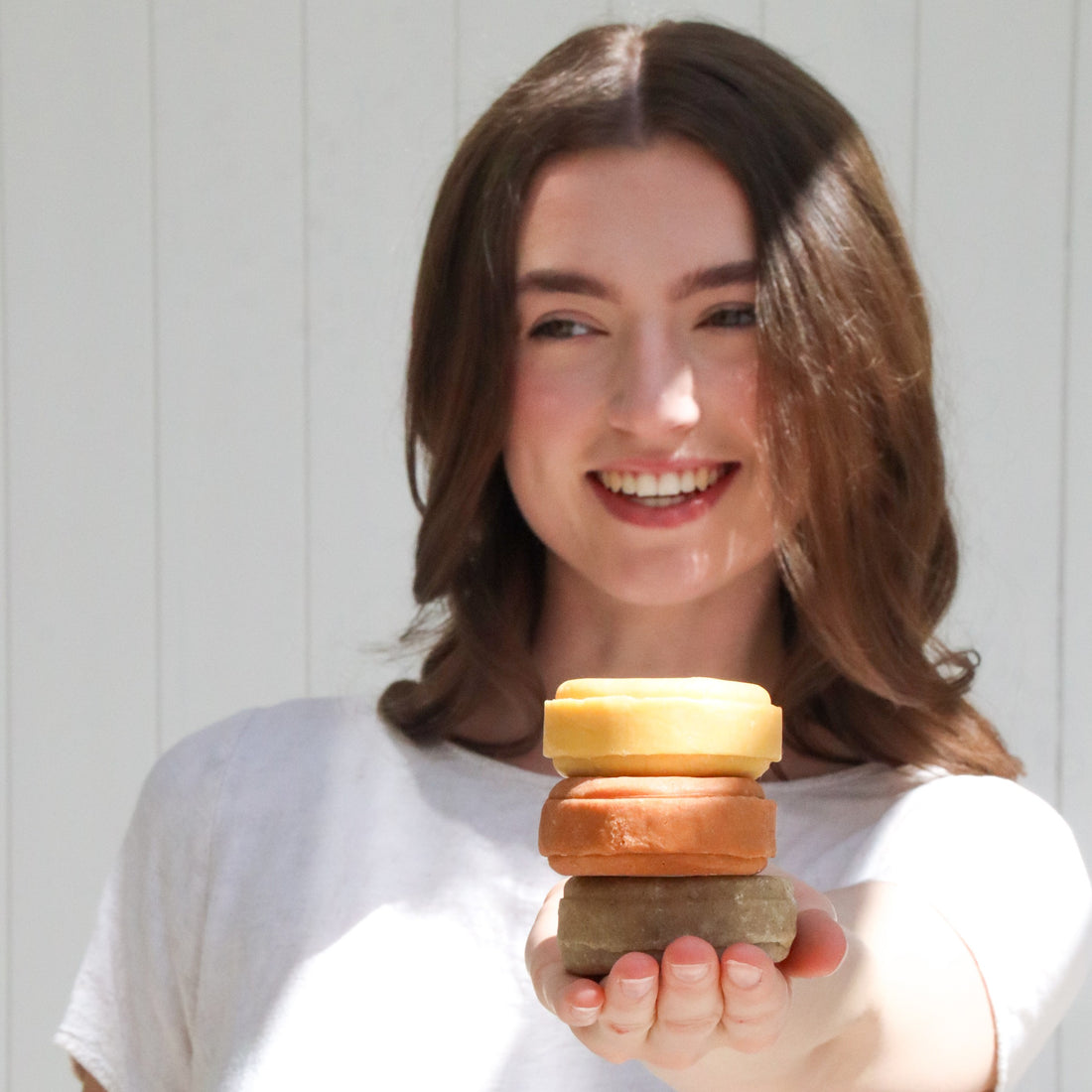 Woman holding shampoo bars